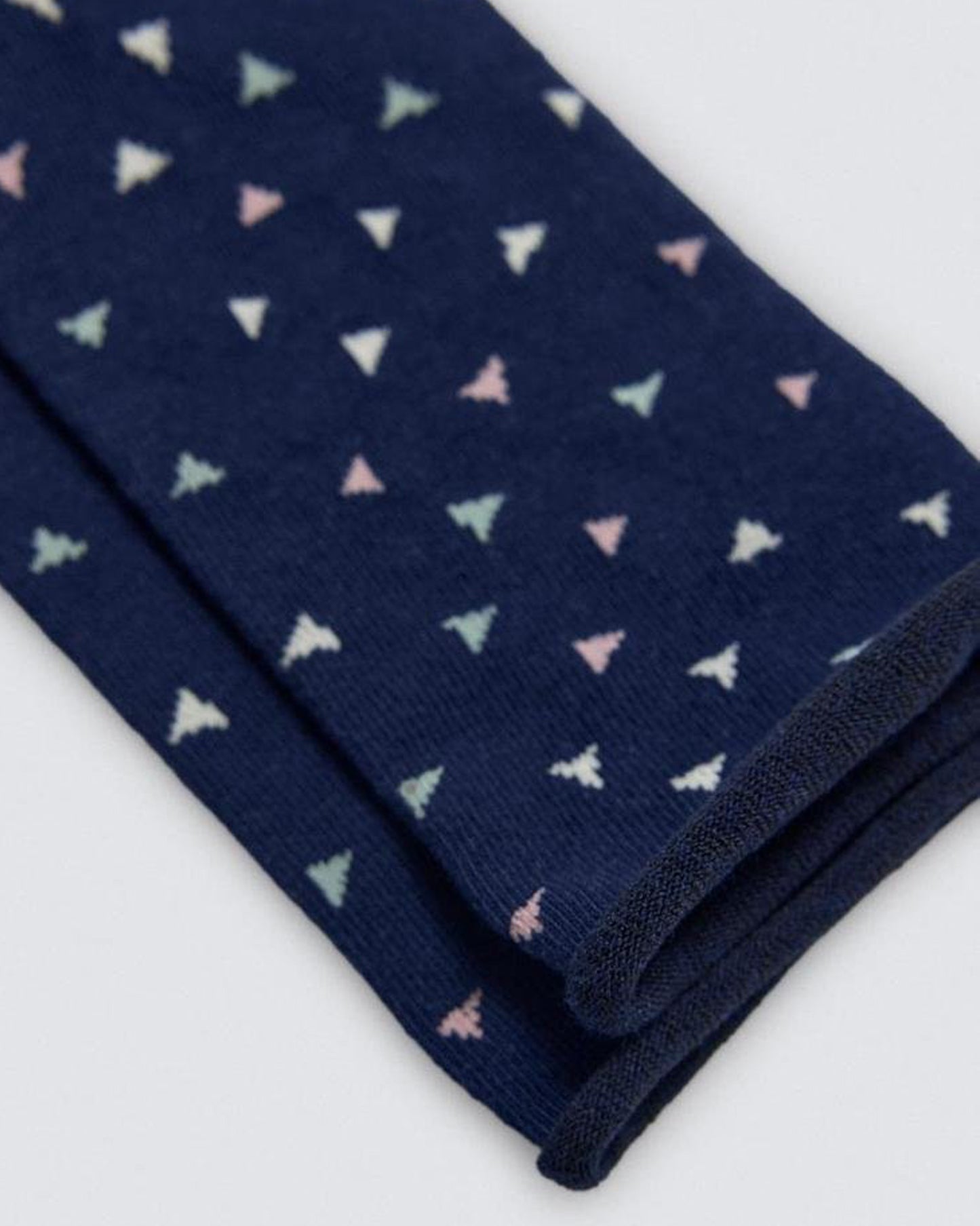 Navy blue socks with small colorful triangle patterns on a white background