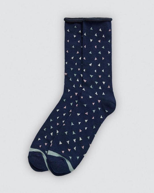 Navy sock with small white triangle pattern on a light gray background