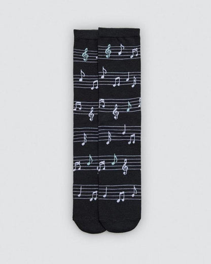 Black socks with white musical note pattern on a light gray background