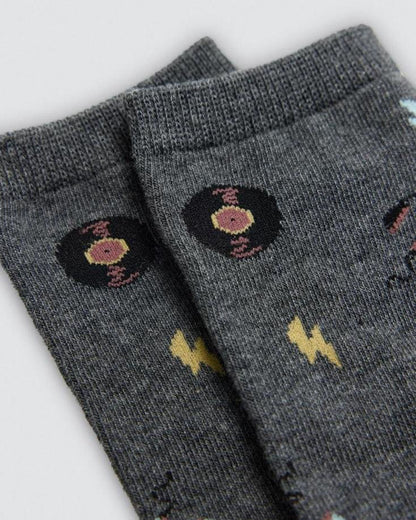 Gray socks with black and yellow vinyl and lightning bolt pattern on a light grey background