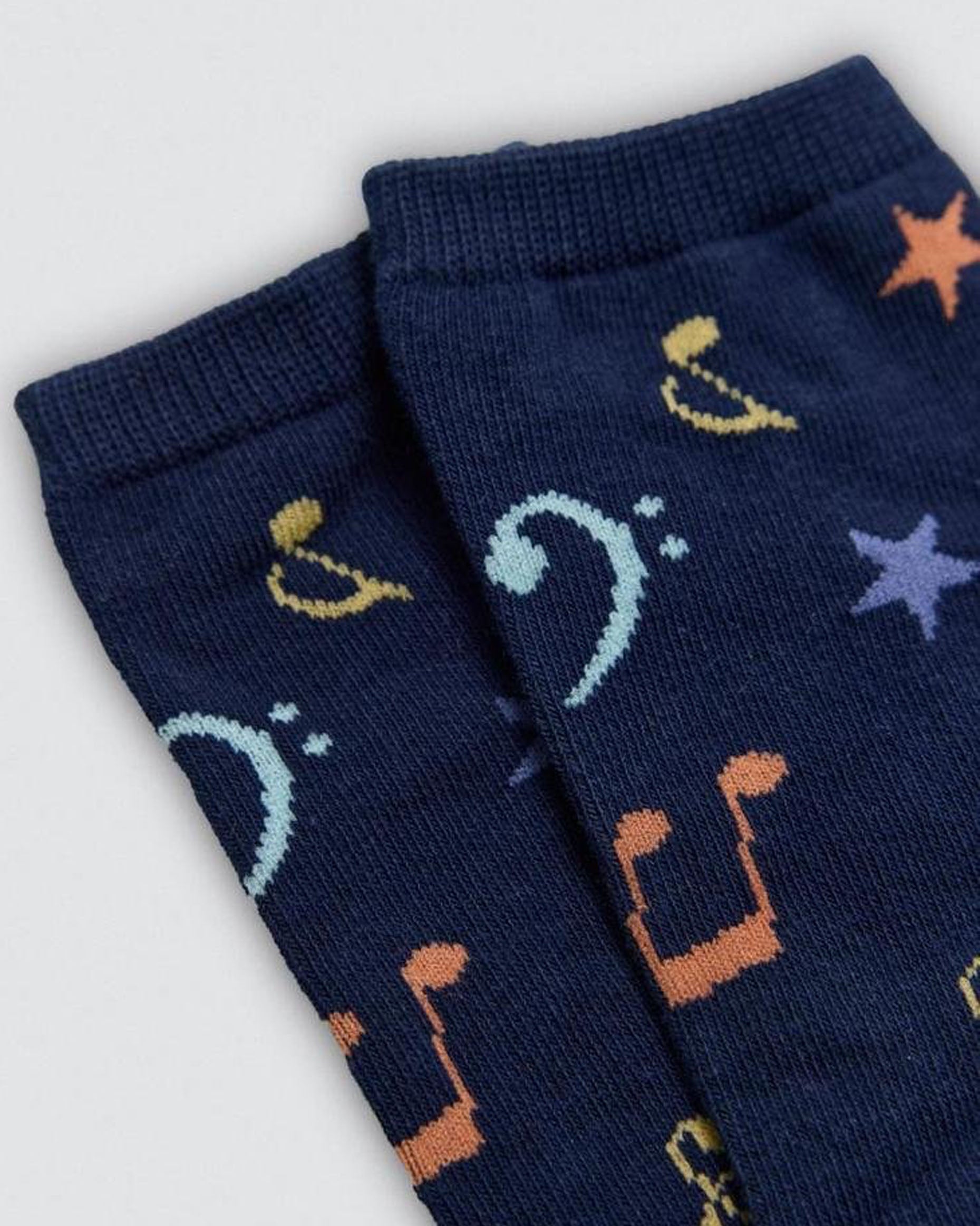 Navy blue socks with musical note pattern on a light gray background