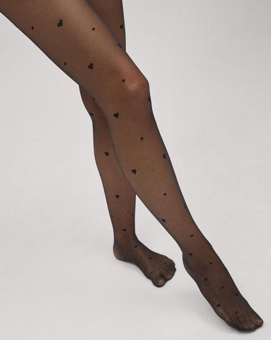 Sheer black fashion tights with a small woven heart and spot pattern.