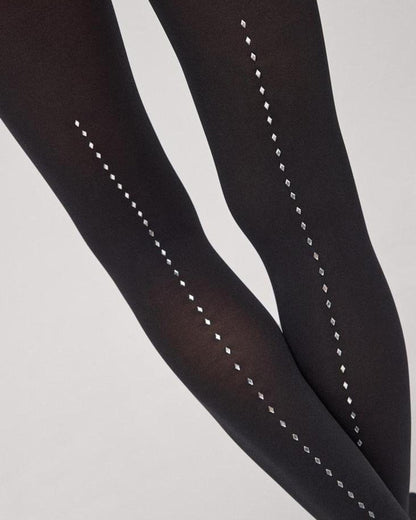 Close up of black opaque tights with a dotted diamanté back seam