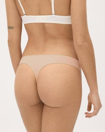 Nude Soft and comfortable low rise thong made with anti-allergic cotton.
High adaptability with elastane, this thong is slim with hand re-meshed non-marking seams. Back view.