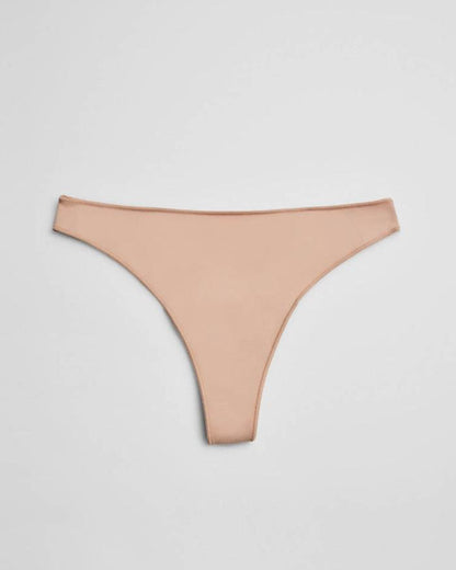 nude thong underwear on a light grey background