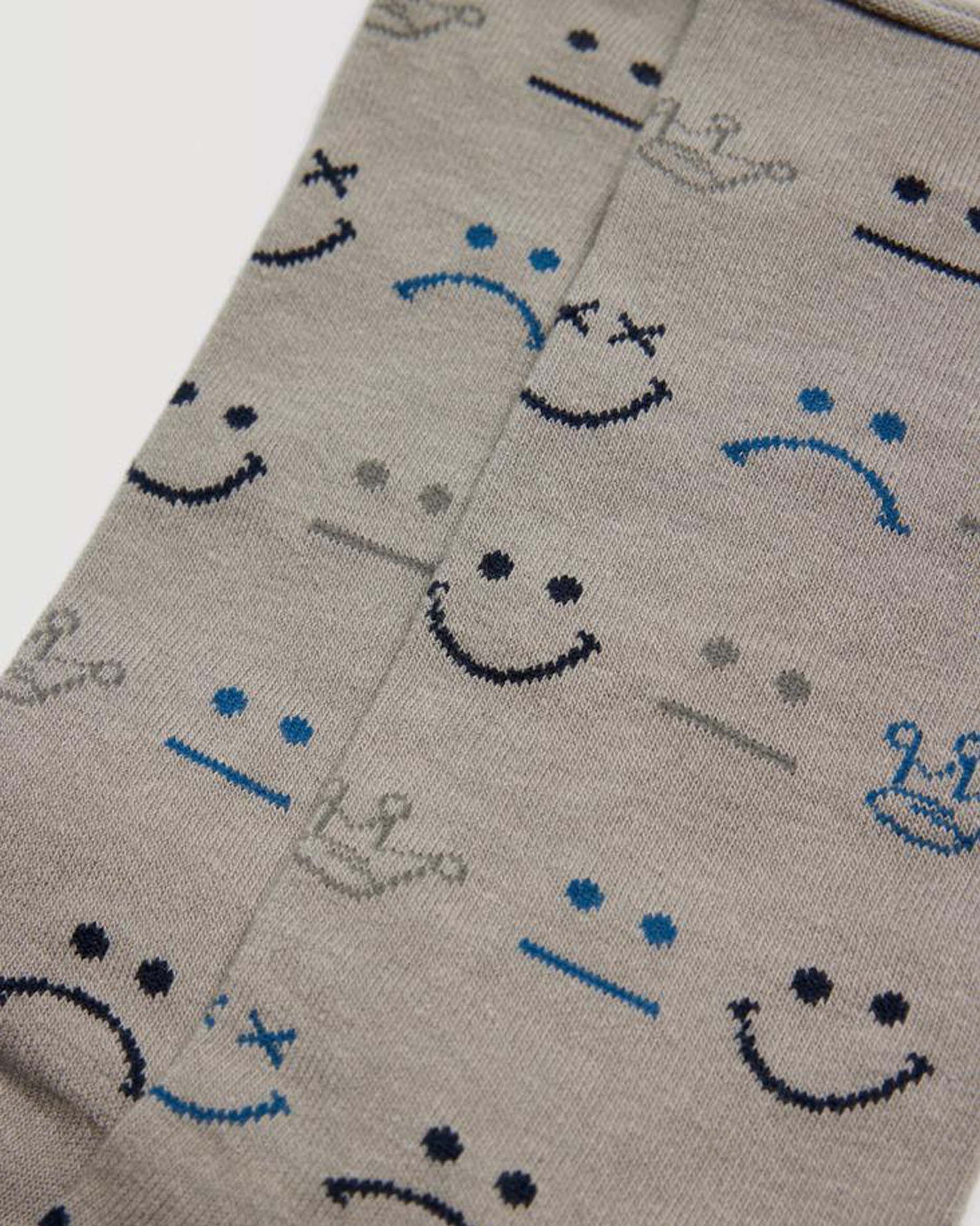 Light grey cotton mix crew length no cuff ankle socks with an all over assorted doodle faces and crown pattern in blue, black and grey.