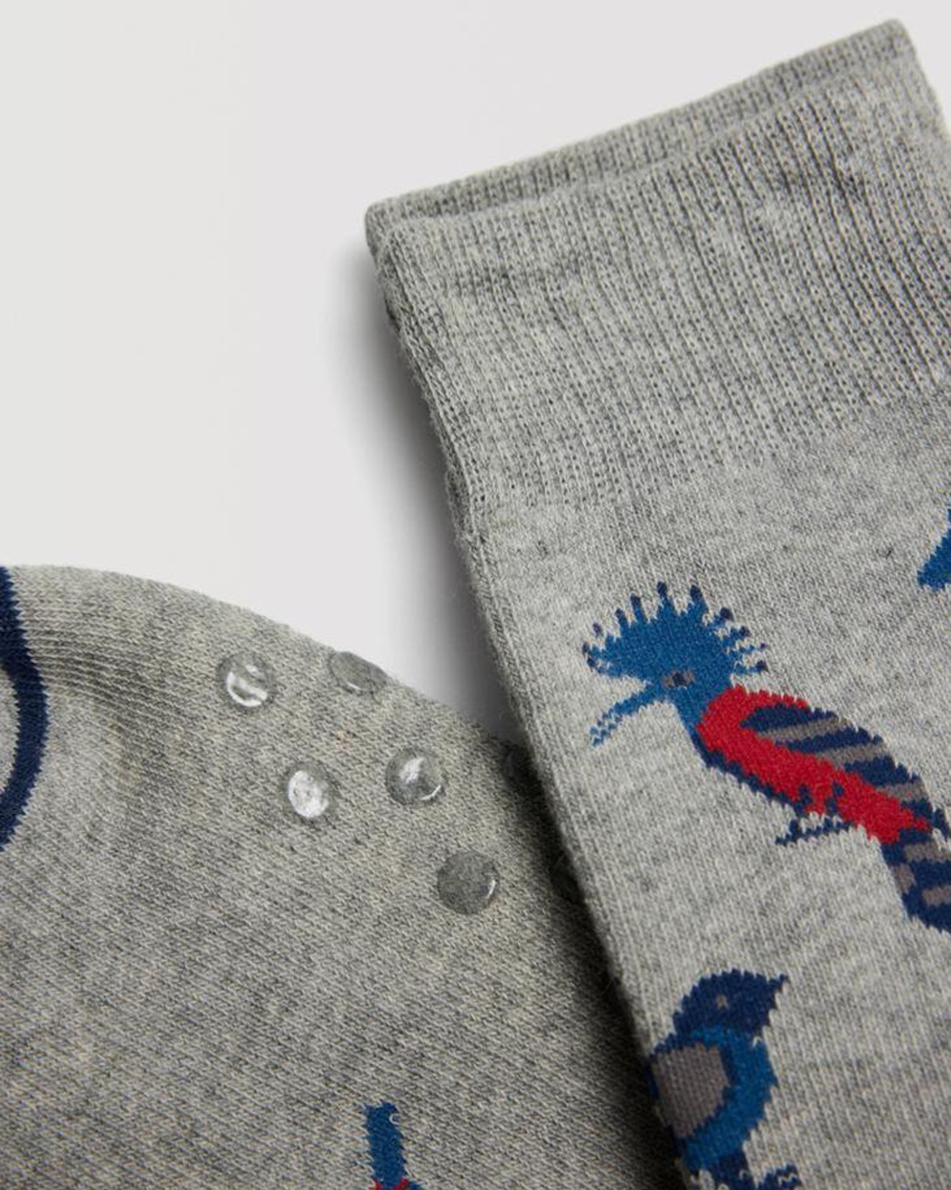 Ysabel Mora 22888 Bird Slipper Socks - Light grey thick and warm terry lined cotton mix crew length ankle socks with an all over exotic birds pattern in red, blue and navy, dotted non-slip sole and deep elasticated comfort cuff.