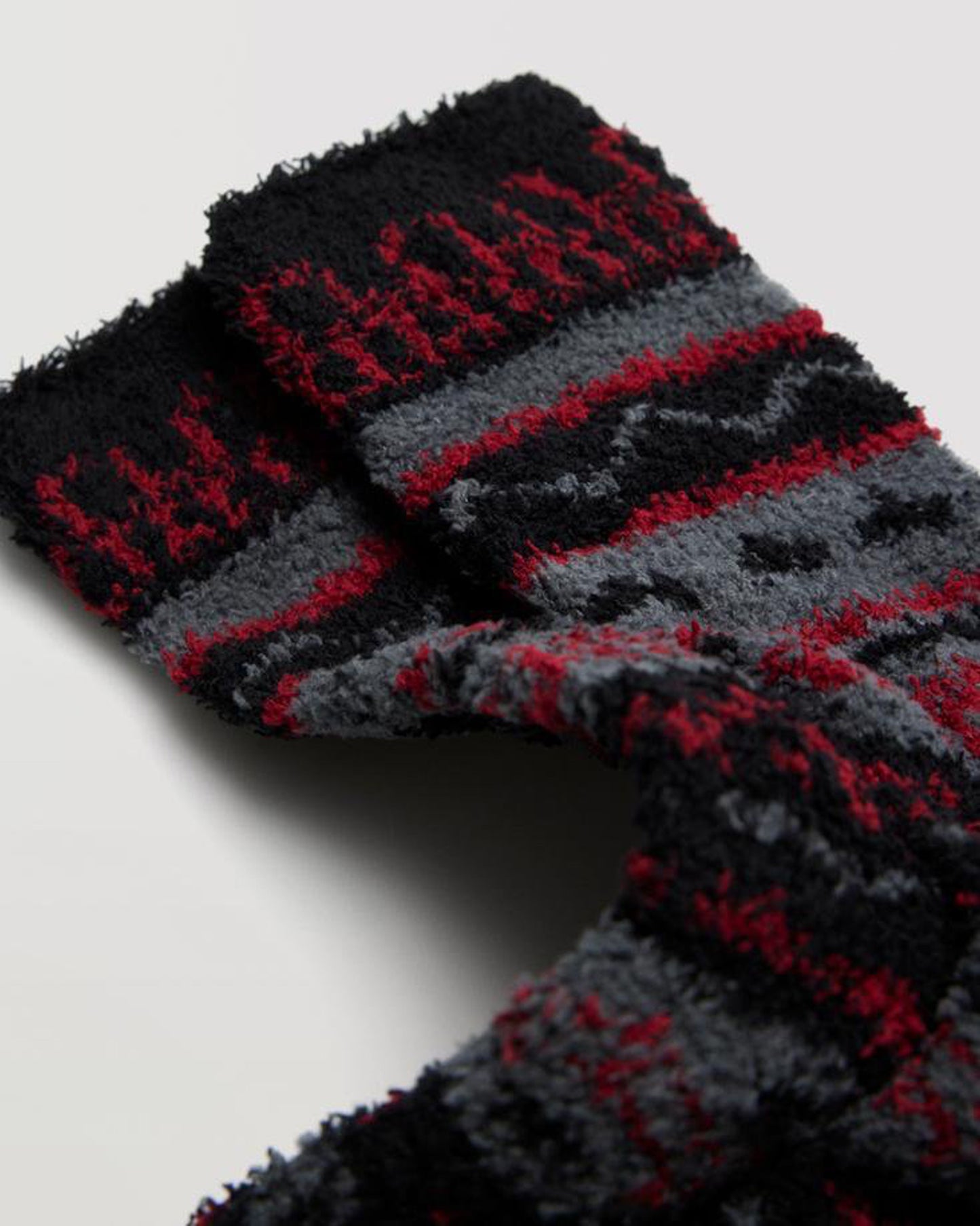 Soft, fluffy and warm patterned socks in black, red and grey.