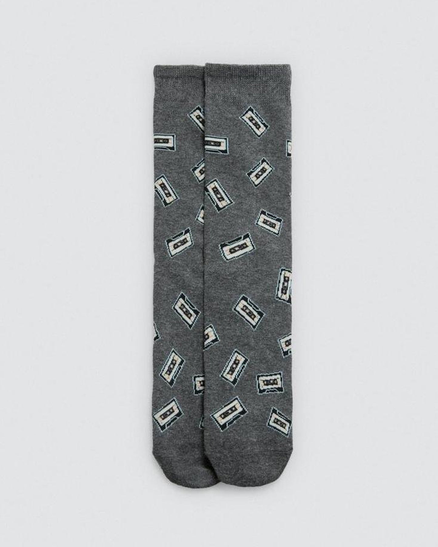 Grey socks with cassette tape pattern on a light gray background