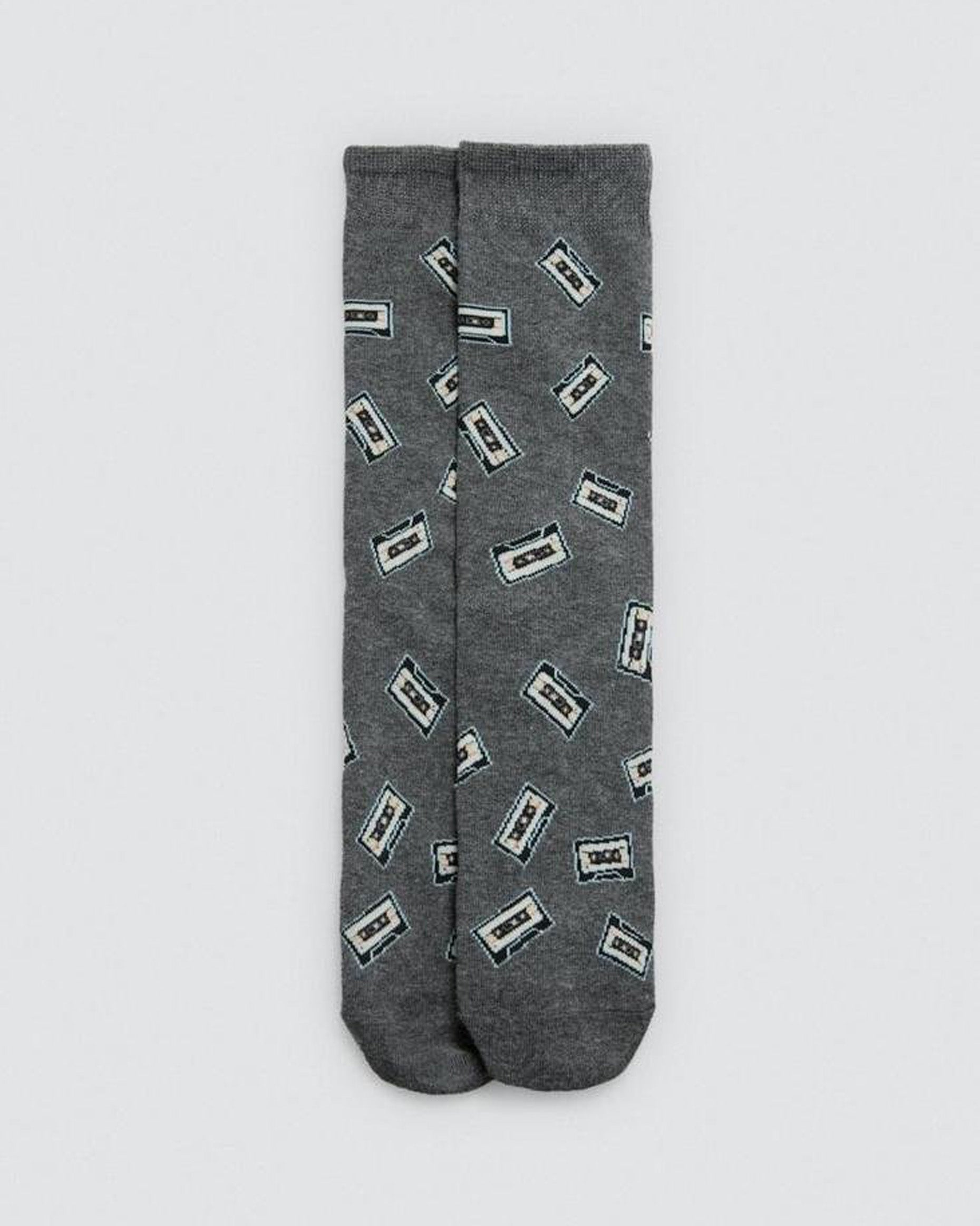 Grey socks with cassette tape pattern on a light gray background