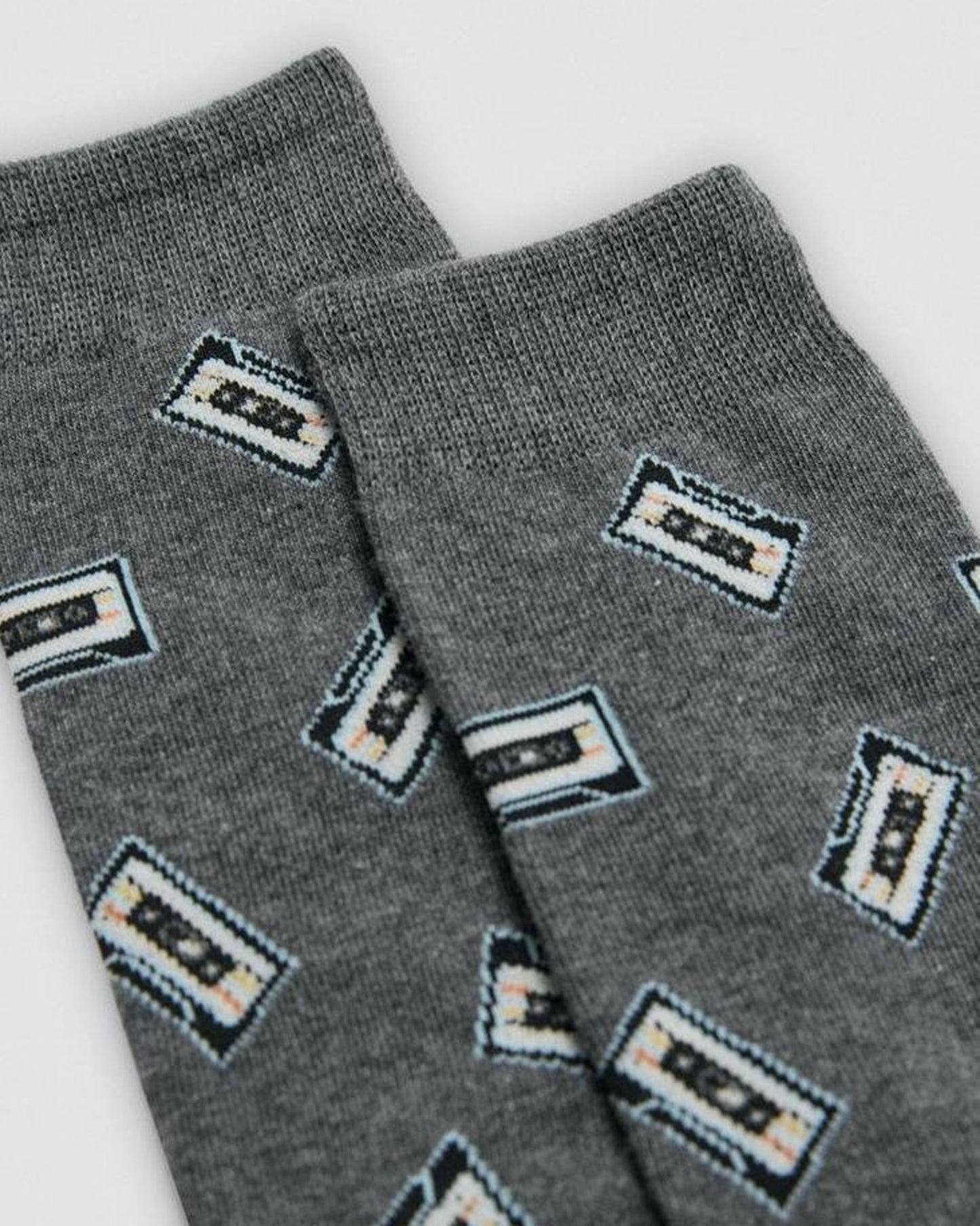 Gray socks with cassette tape pattern on a white background