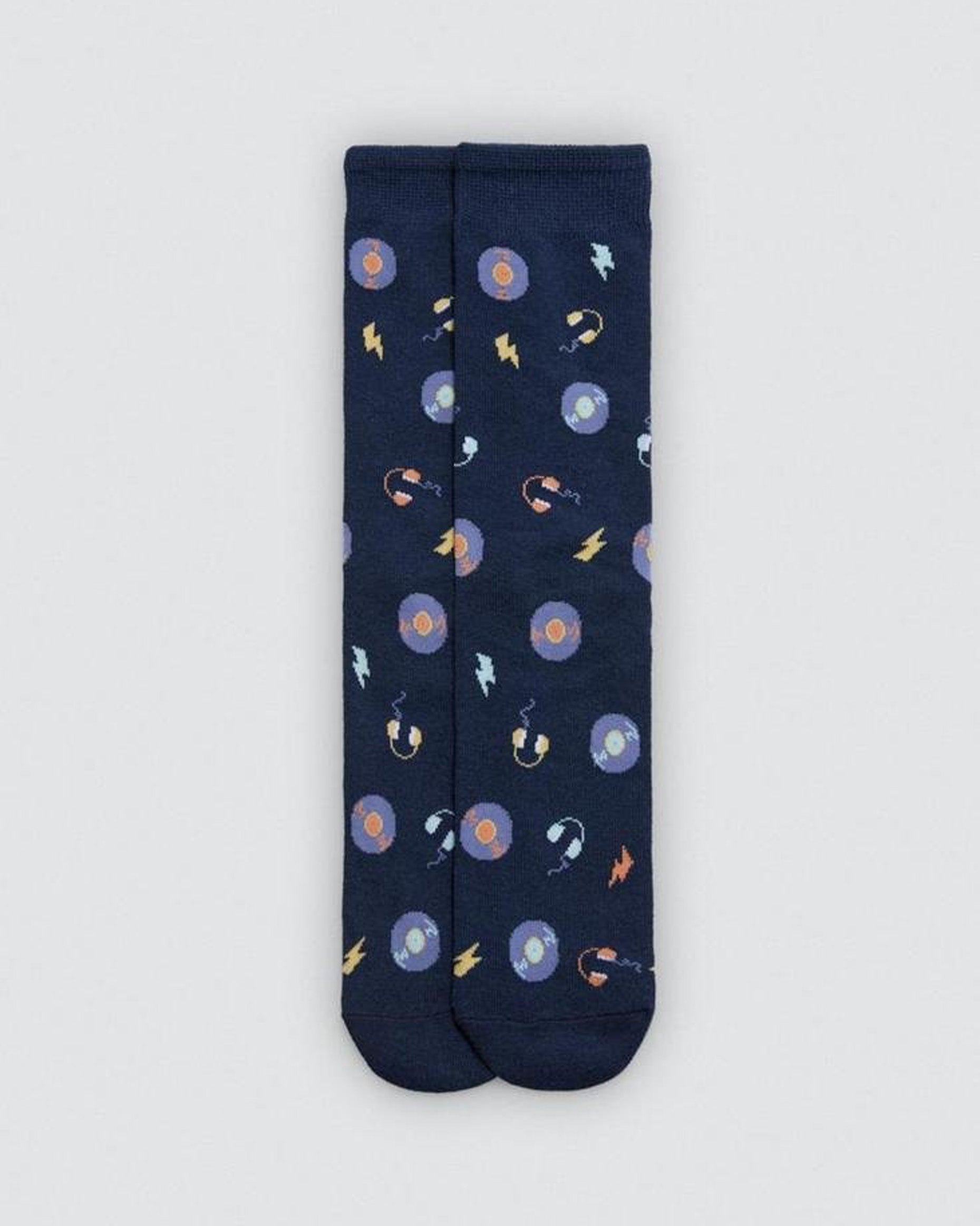 Navy blue sock with music themed pattern of vinyl records, headphones and lightning bolts on a light grey background