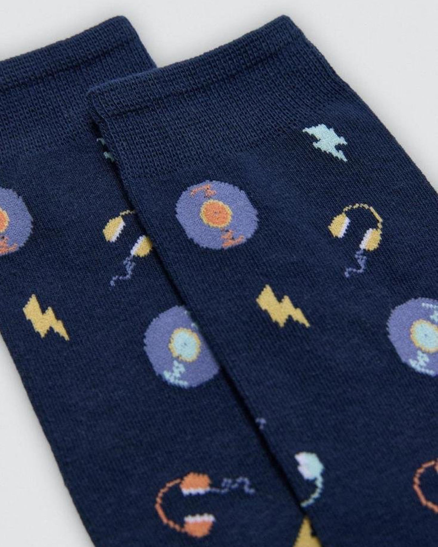 Navy blue socks with music themed pattern on a white background