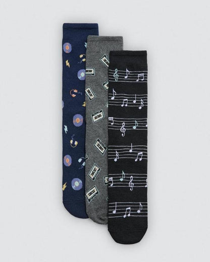 Three pairs of socks with different music themed patterns on a light gray background