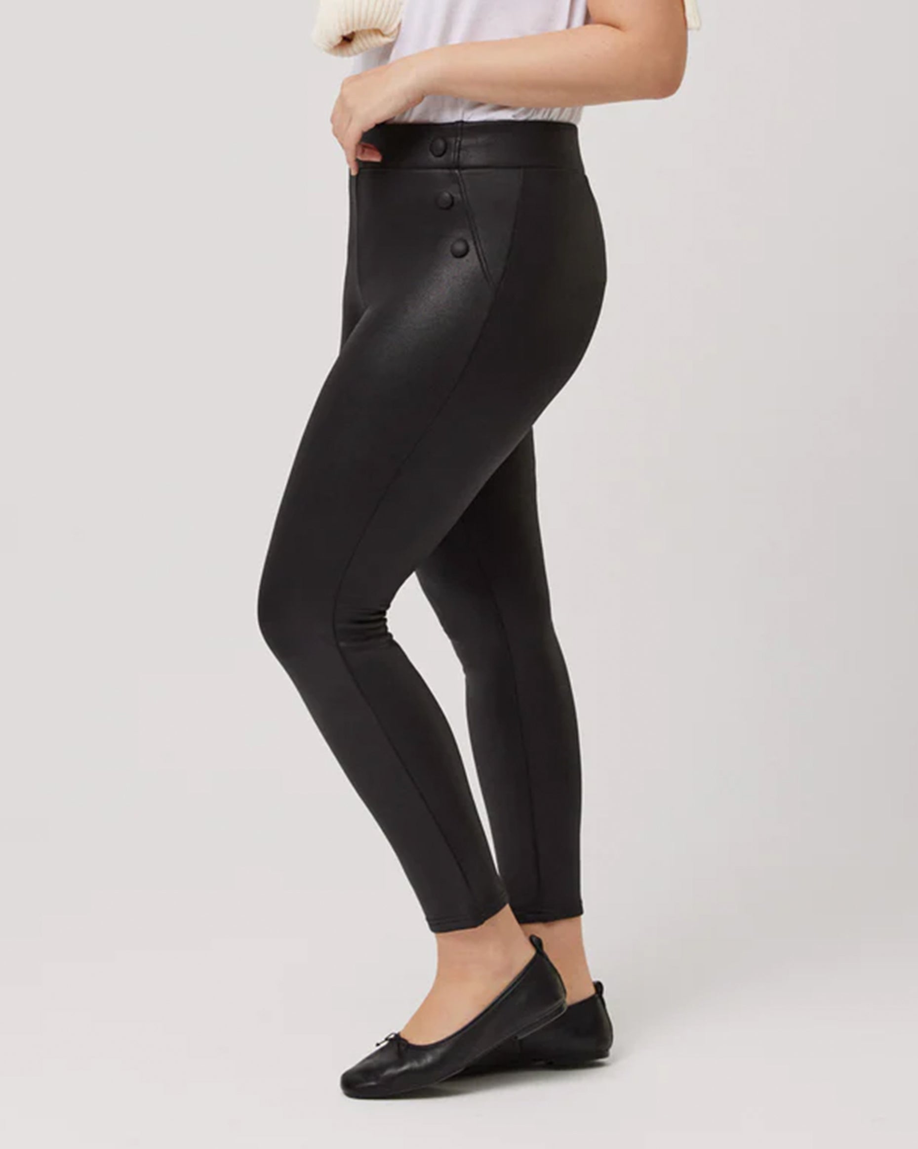 Ysabel Mora 70166 Waxed Thermal Leggings - High rise black trouser leggings with waxed effect finish, warm fleece lining, faux front pockets with covered buttons and deep elasticated waistband. Side view.