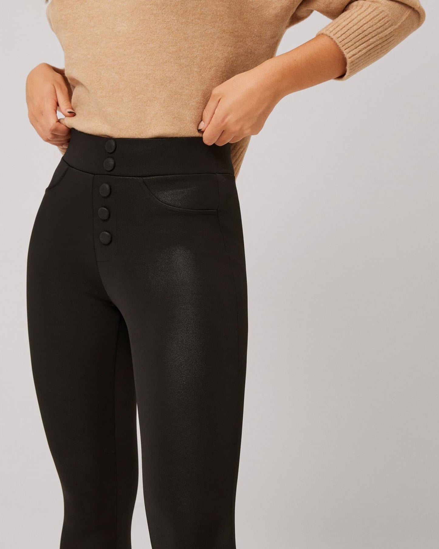 Ysabel Mora 70294 Waxed Thermal Leggings - Black high waisted trouser leggings (treggings) with waxed / faux leather effect coating, warm fleece lining, faux front black buttons and faux front pocket stitching, worn with camel jumper.