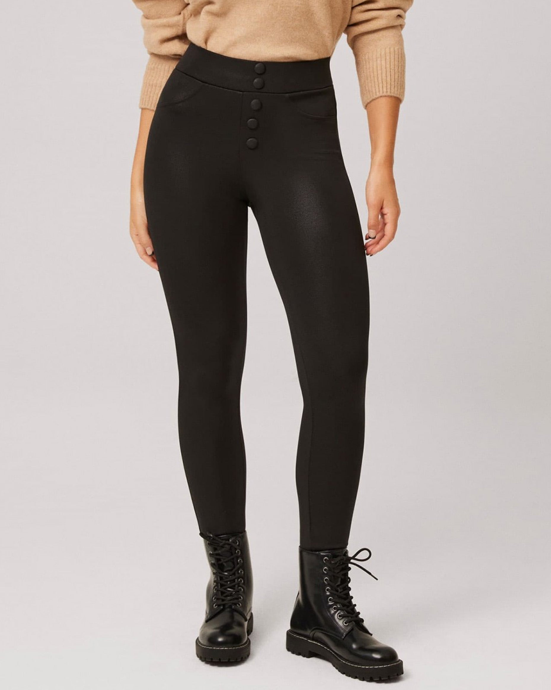 Ysabel Mora 70294 Waxed Thermal Leggings - Black high waisted trouser leggings (treggings) with waxed / faux leather effect coating, warm fleece lining, faux front black buttons and faux front pocket stitching, worn with camel jumper and black laced up boots.