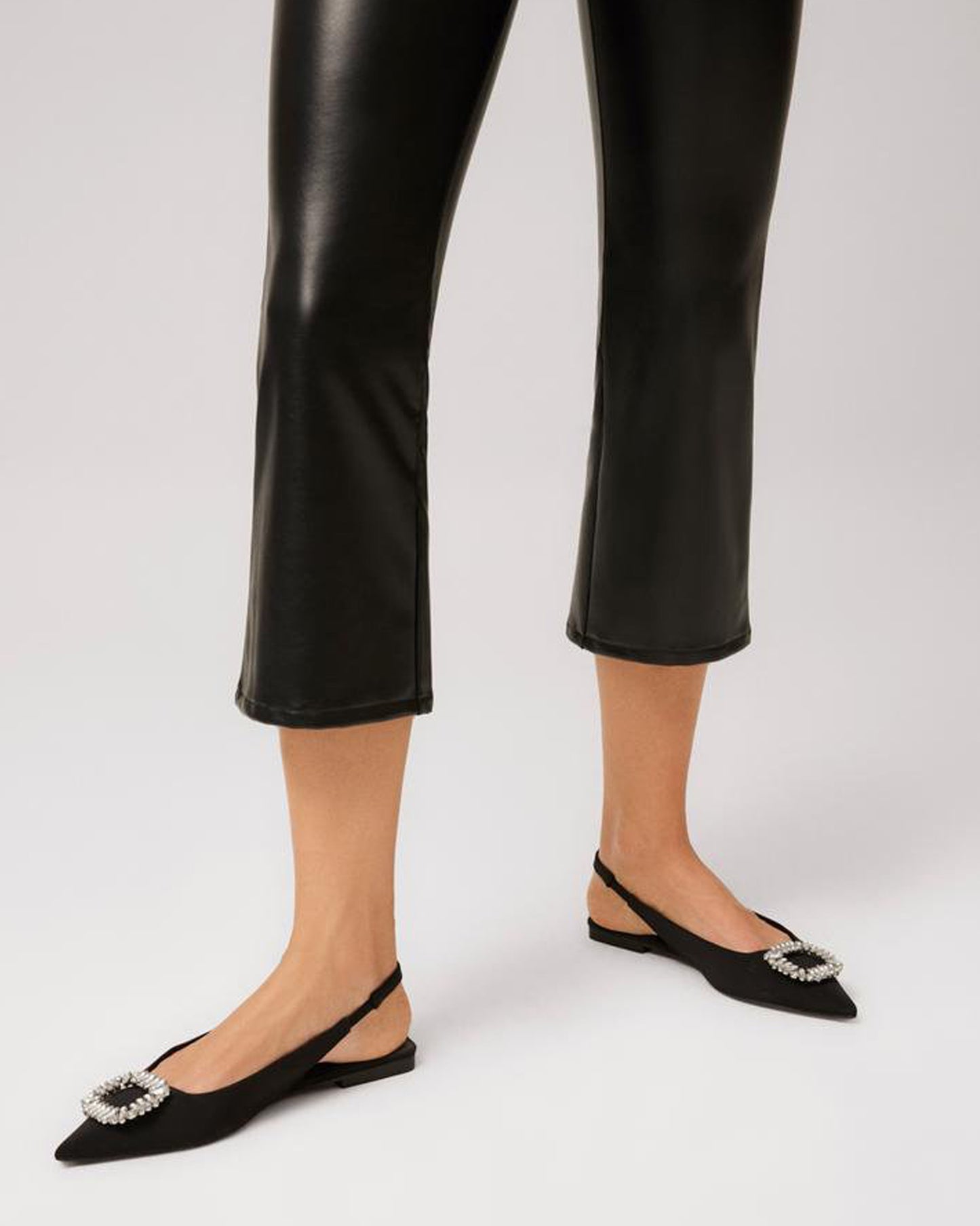 Ysabel Mora 70296 Faux Leather Cropped Pants - Black flared crop faux leather thermal leggings with a soft and warm plush lining. Ysabel Mora 70296 Faux Leather Cropped Pants - Black flared crop faux leather thermal leggings with a soft and warm plush lining. Worn with sling back pointed jewelled shoes.