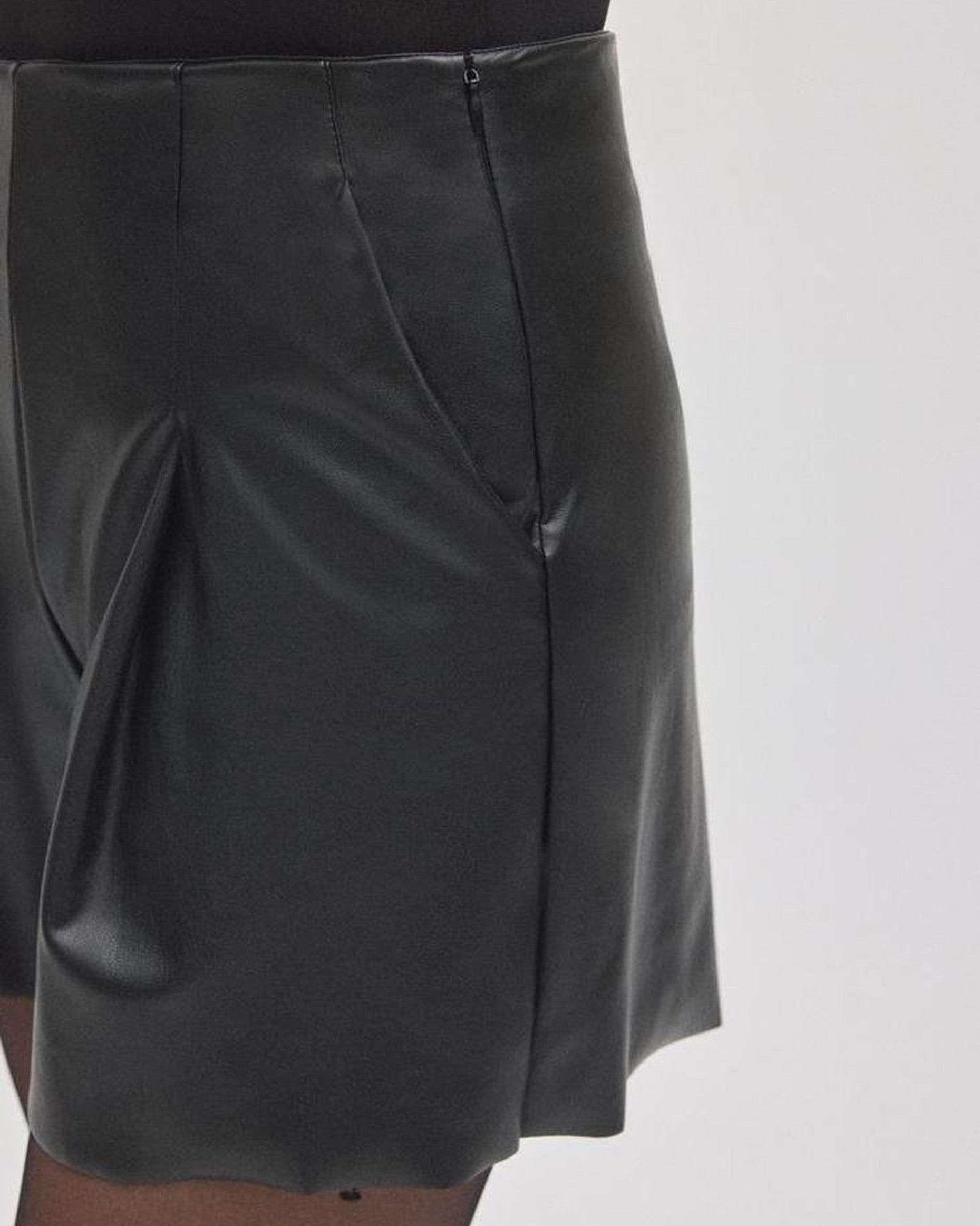 Black leather shorts on a white background