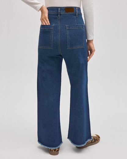 Blue jeans worn by a person on a white background