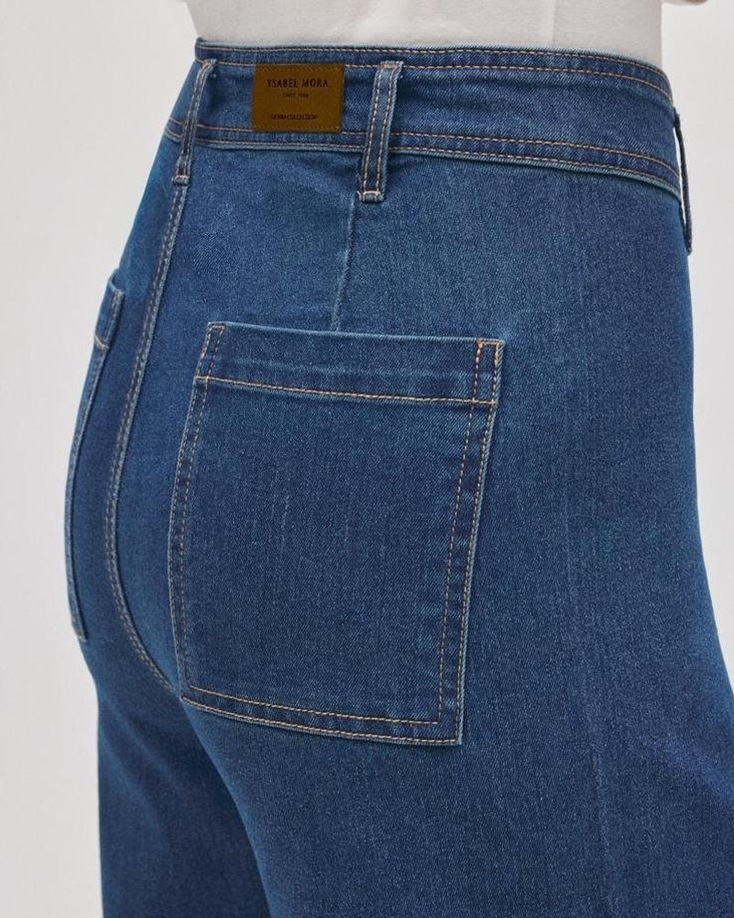 Blue jeans with a visible brand label on a white background