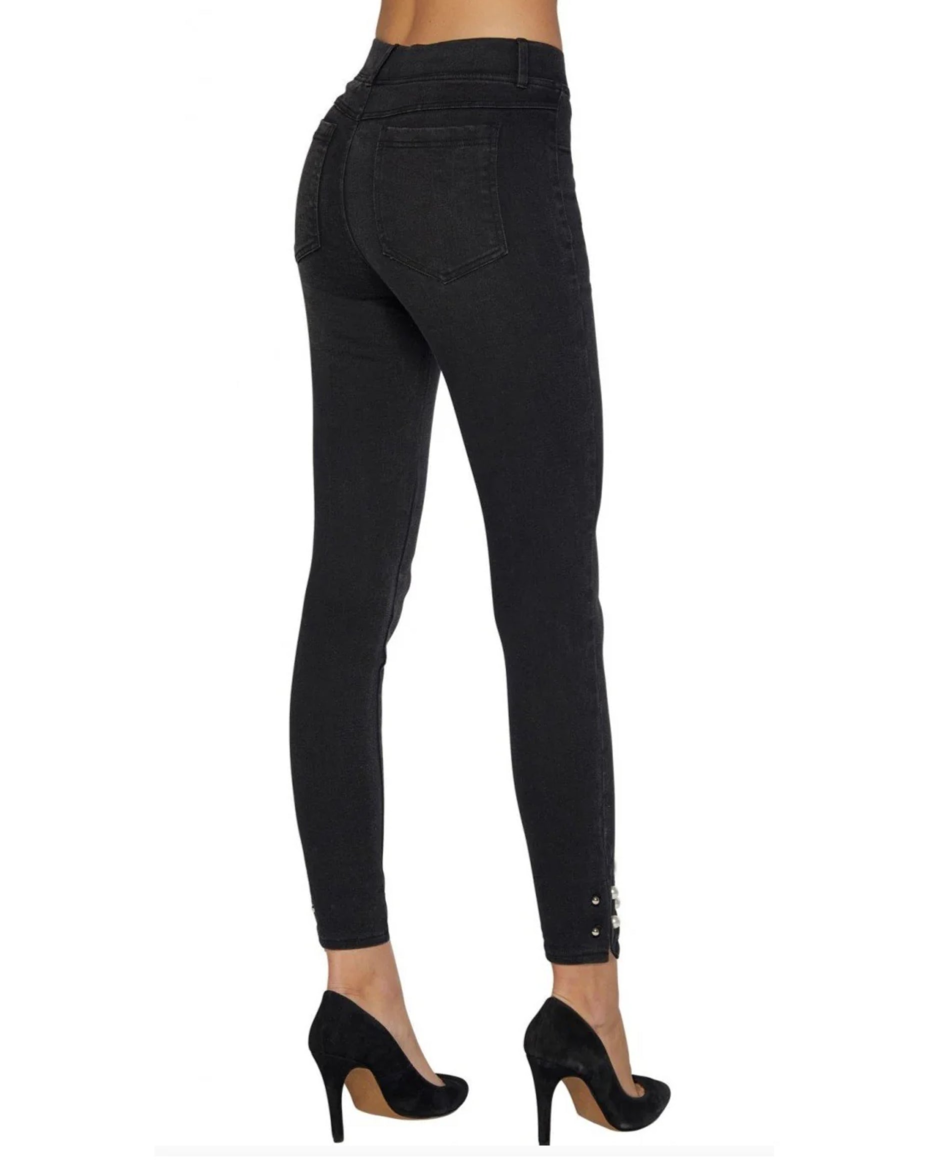 Black jeans worn by a person on a white background