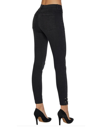 Black jeans worn by a person on a white background