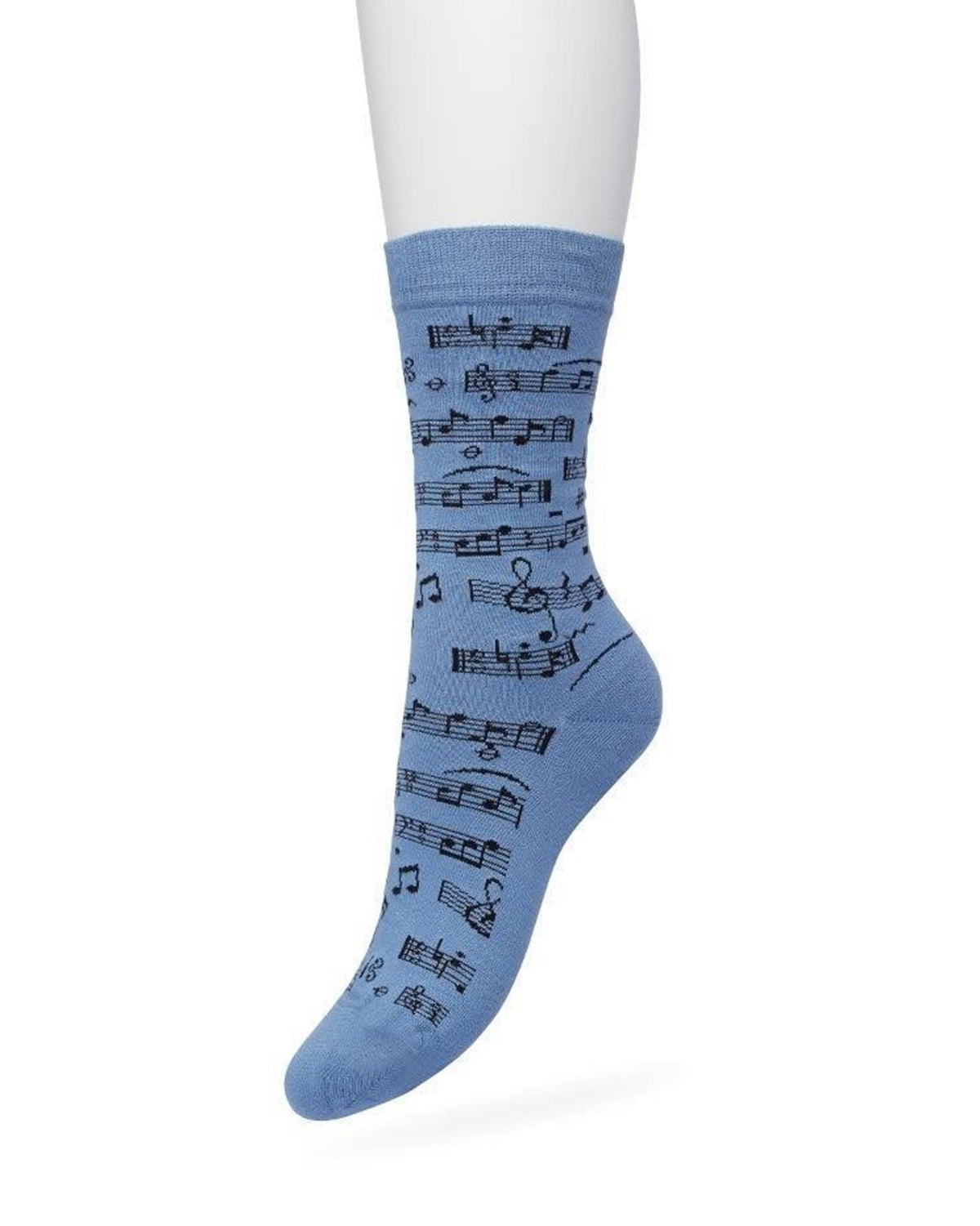 A single light blue crew sock with a black musical staff and notes pattern, shown on a white mannequin leg against a white background.
