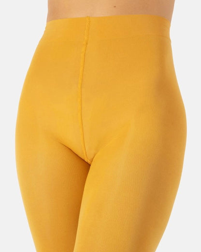 Close-up of a model wearing high-waisted, solid mustard yellow leggings against a light gray background.