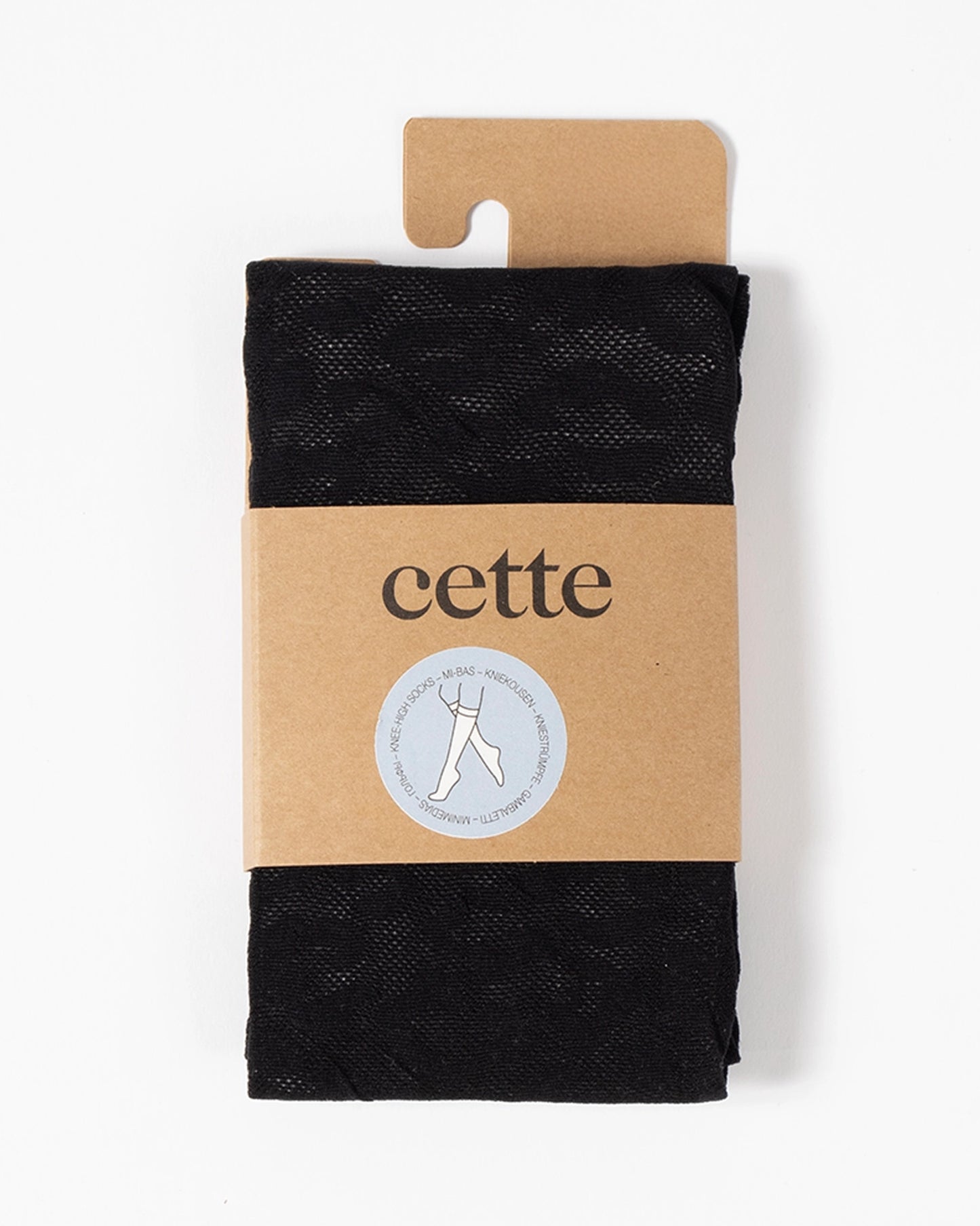 Black leopard print socks in a cardboard packaging with 'cette' branding on a white background