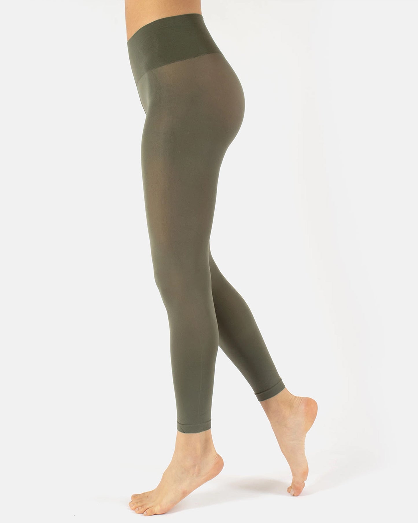 Olive green leggings worn by a person on a white background