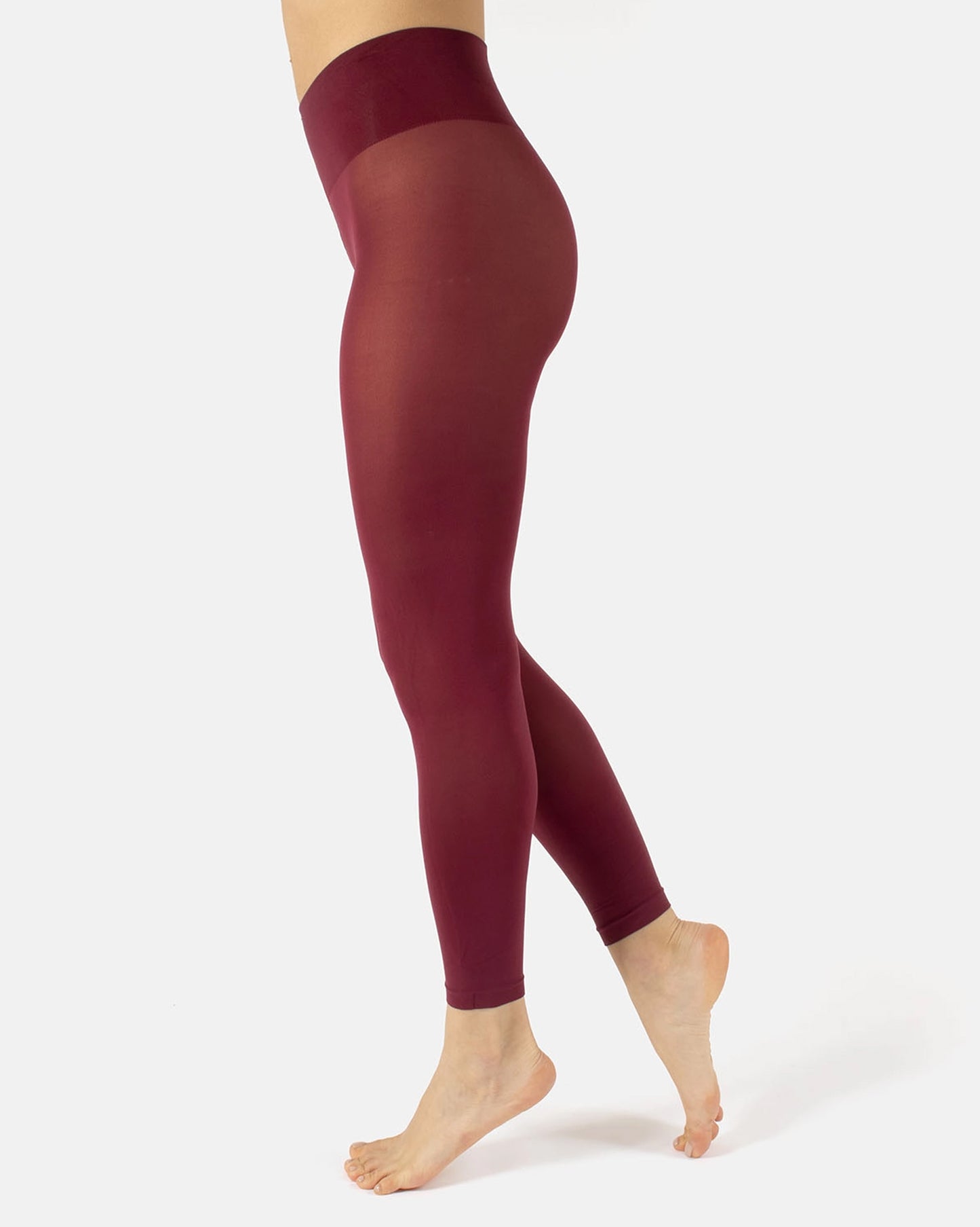 Maroon leggings worn by a person on a white background