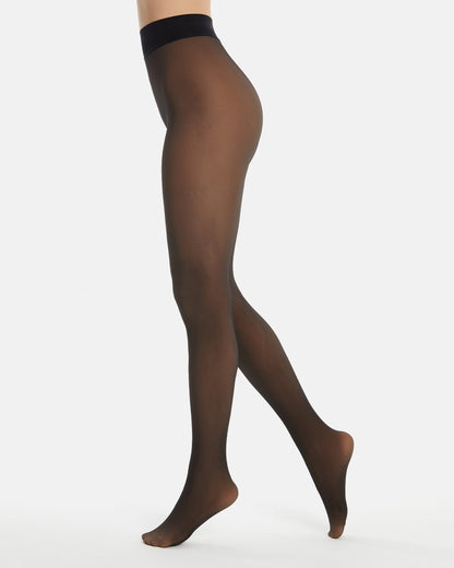 Sheer black look opaque tights worn by a person on a white background