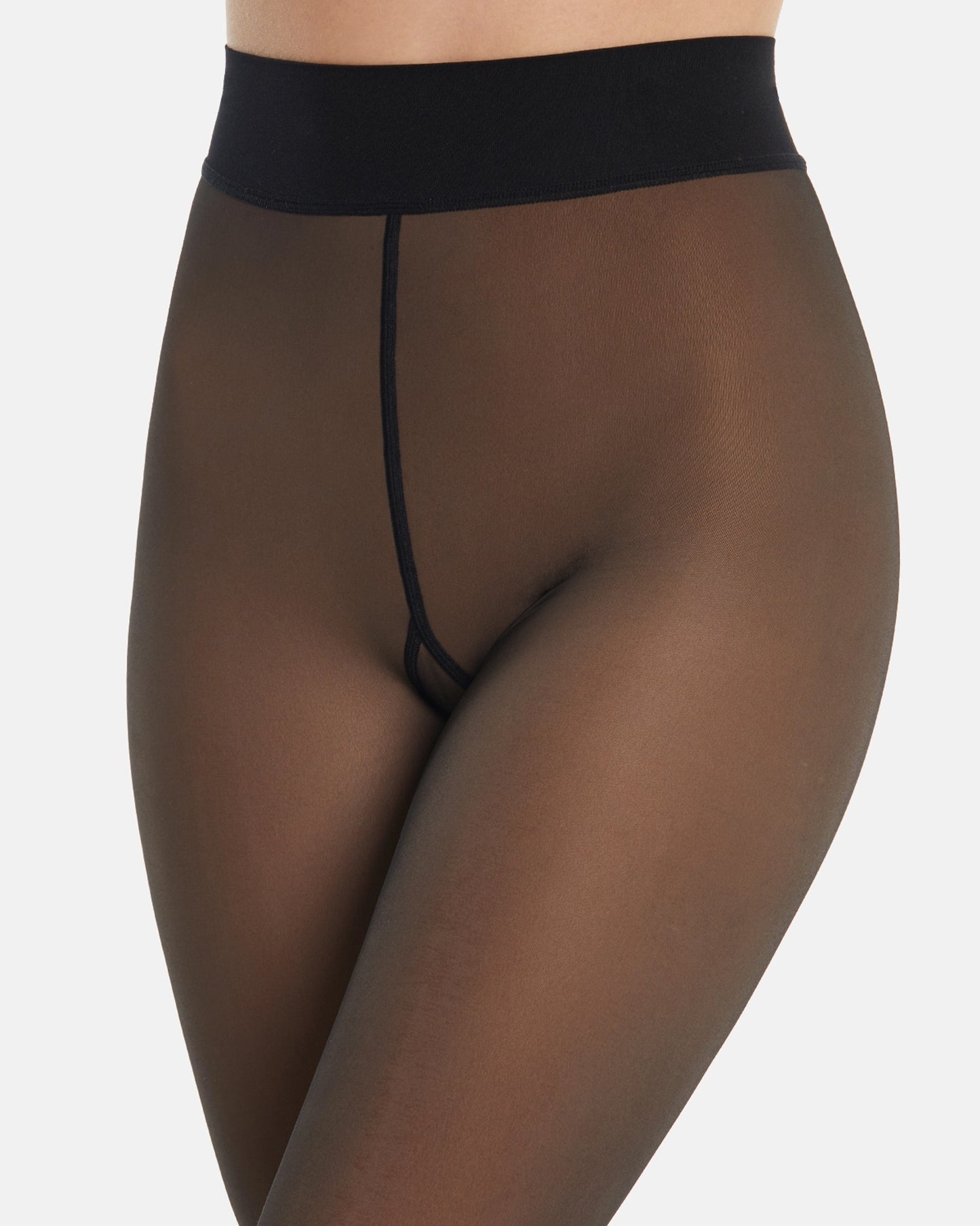 Close up of waist band of sheer black look opaque tights worn by a person on a white background