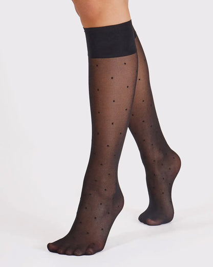 Black polka dot sheer knee-high socks on a white background