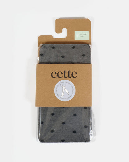 Packaged sheer black socks with black dots on a beige card, featuring the brand 'cette'.