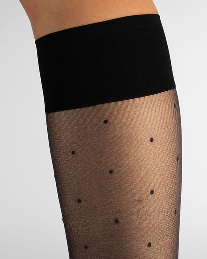 Black knee-high socks with black polka dots and a black cuff on a white background