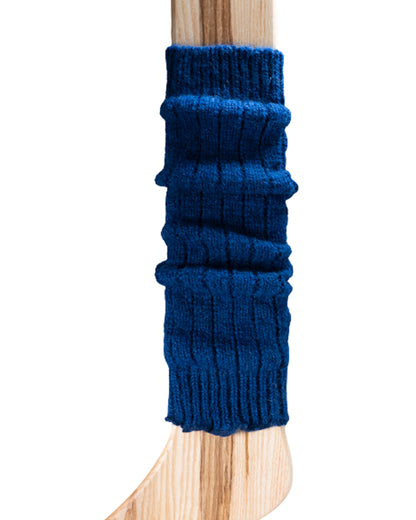 A dark royal blue ribbed knitted leg warmer displayed on a wooden model.