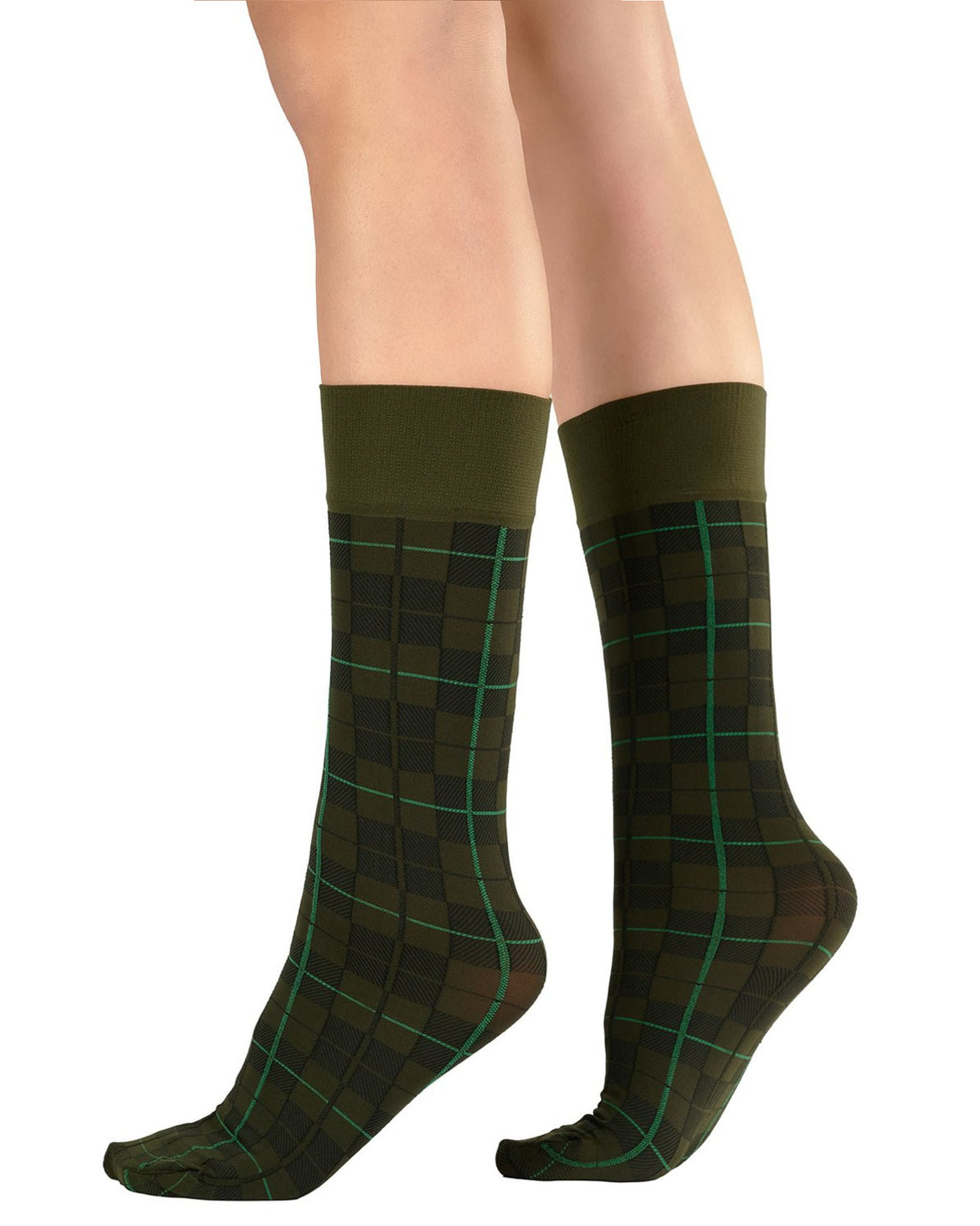 A pair of knee-high socks with a dark green and black tartan plaid pattern outlined by thin green grid lines, shown on a model's legs against a white background.