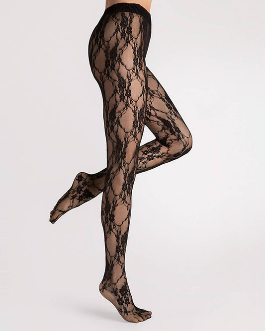 Fiore Donatella Tights - Black floral lace tights on a micro mesh/tulle background with a back seam. Side view.