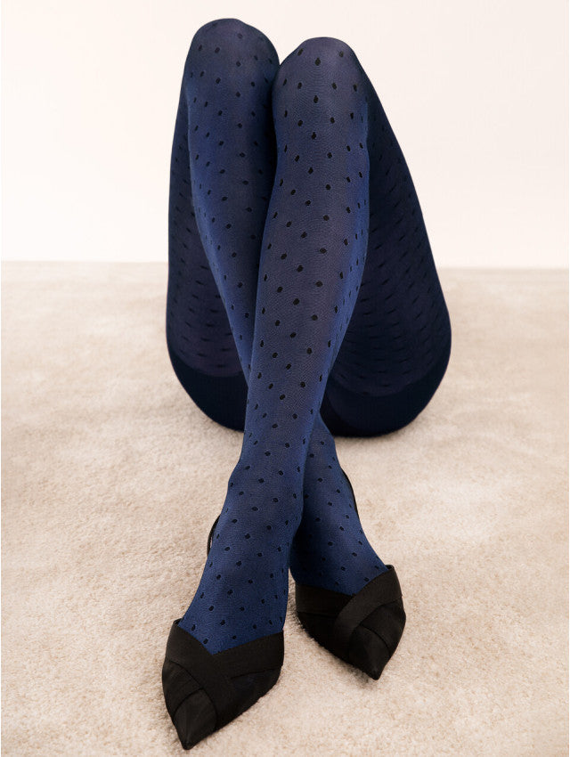 Fiore Dry Pastel Tights - Glossy navy opaque fashion tights with an all over light honeycomb and spot pattern in black, worn with black velvet pointed shoes.