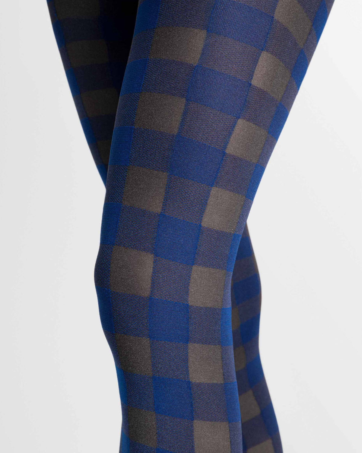 Close-up of a person's legs wearing blue and gray checkered tights against a plain light background.