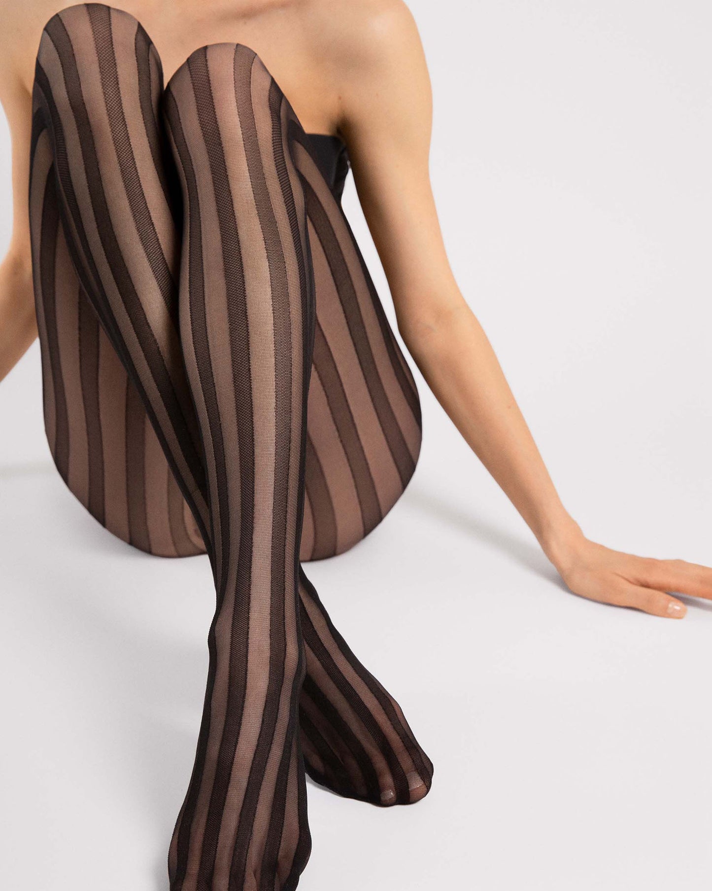 Fiore Raya Tights - Sheer black fashion tights with an opaque woven vertical stripe pattern. Side view.