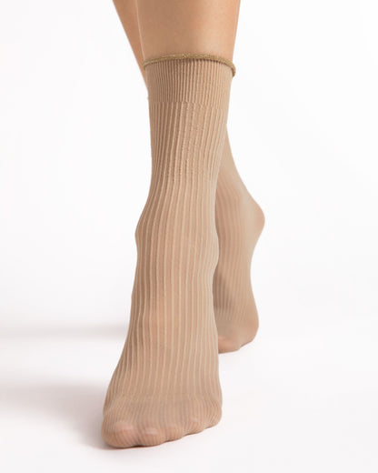 Beige ribbed socks worn by a person on a white background