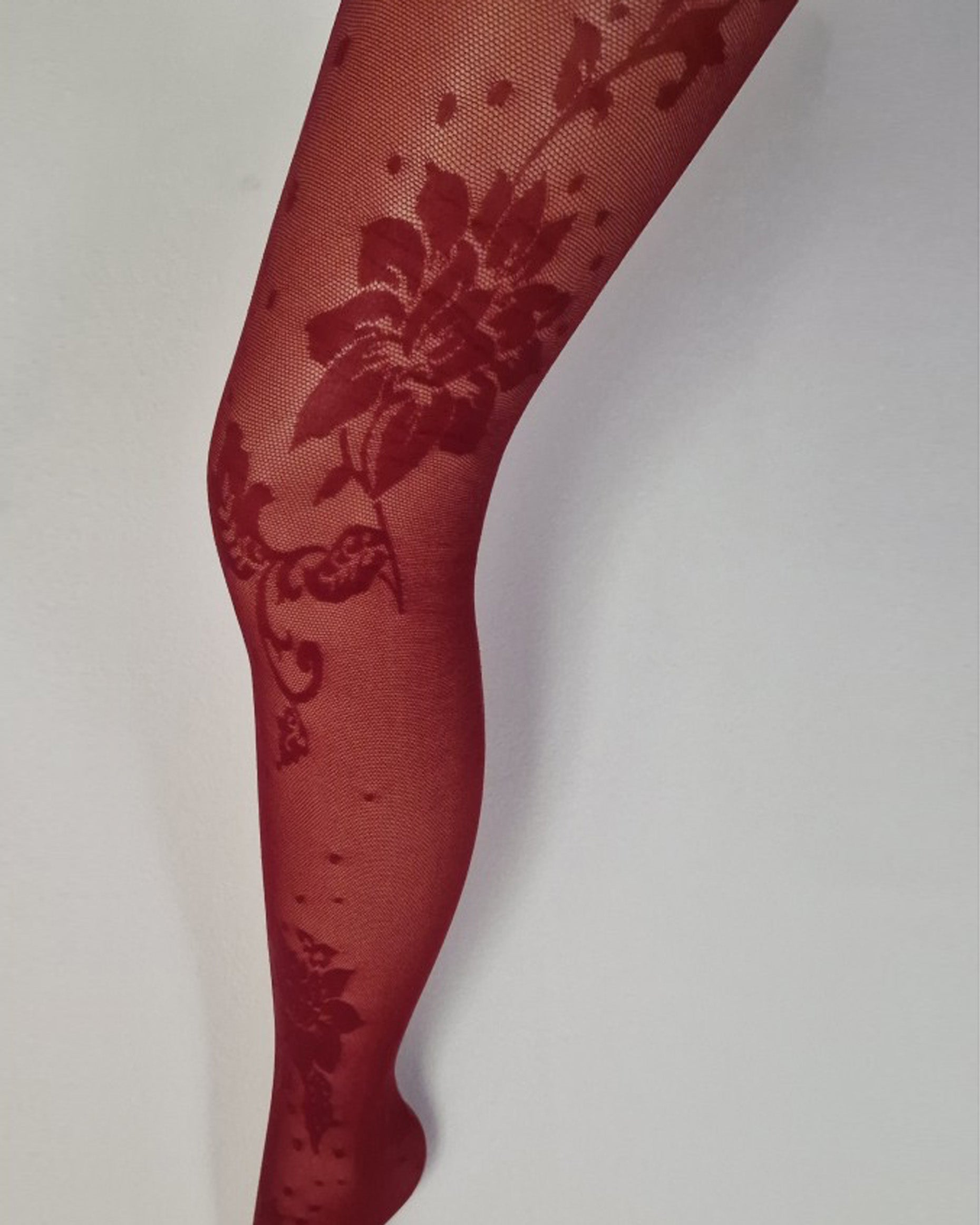 Red floral patterned tights on a white background