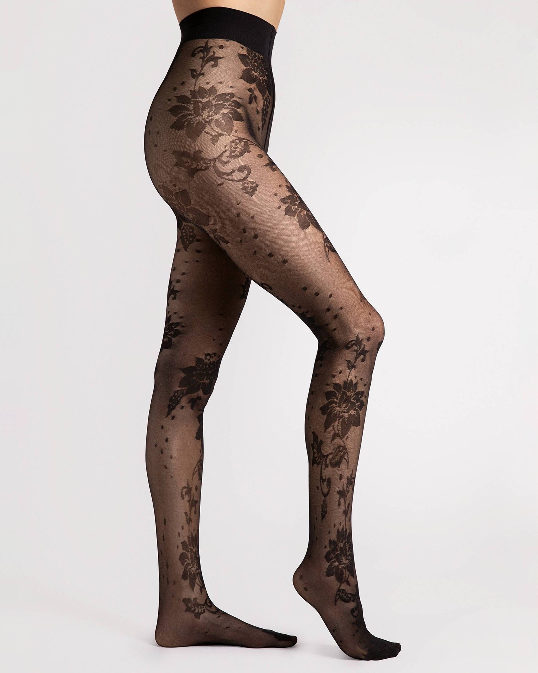 Fiore Sharon Tights - Black semi-sheer micro mesh black fashion tights with a flower and spot pattern, flat seams, hygienic gusset and invisible reinforced toe. Side view.