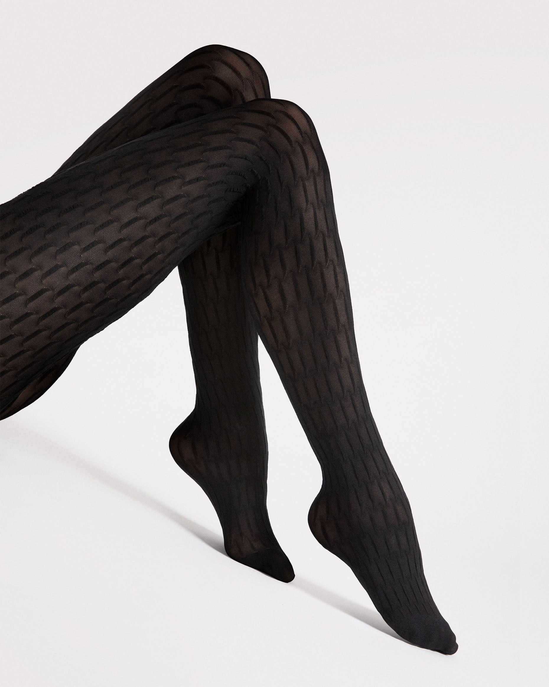 Black textured patterned tights on a white background