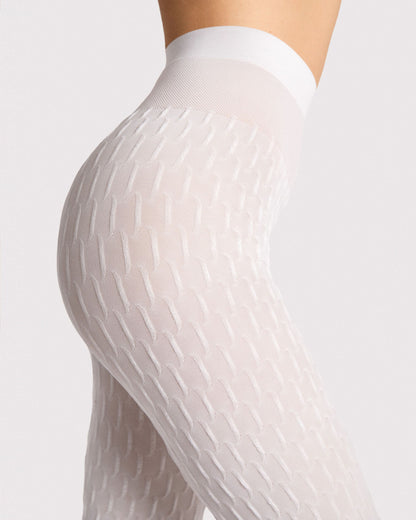 Close-up of a person wearing white textured tights against a light background