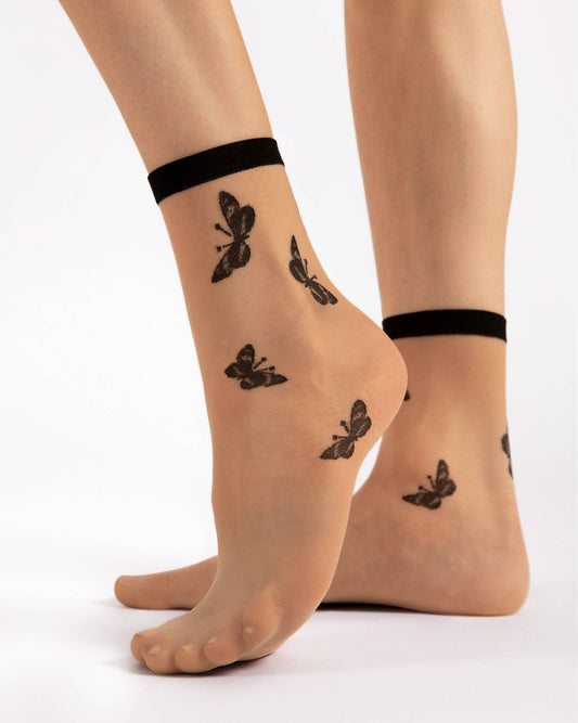Fiore Summer 15 Den - Sheer nude fashion ankle socks with a butterfly pattern in black, plain black elasticated cuff. Side view.