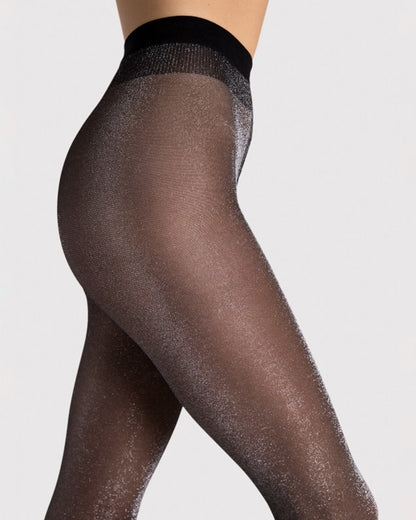Black sheer tights with silver glitter worn by a person on a light grey background